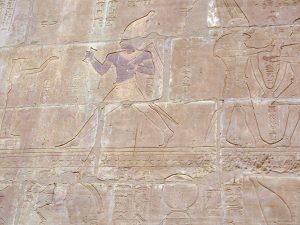 <p>Fig. 7. South wall, upper register. Darius (center), wearing the White Crown, runs with cramp and flail toward the goddess Meret, standing on the House of Gold. Behind Meret stands Amun-Reh of Hibis (image: R. Röllinger).</p>